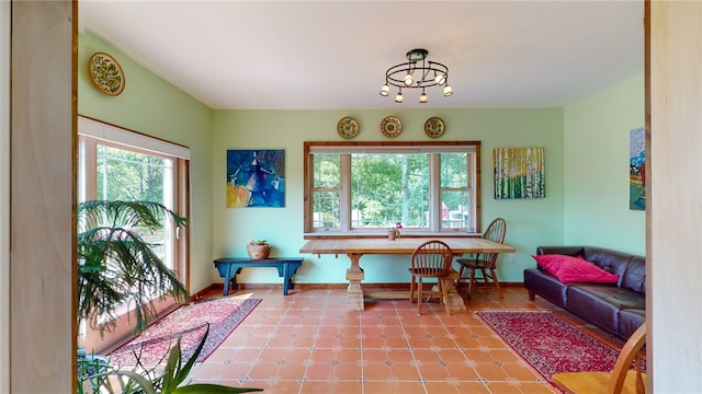 tiled dining area featuring an inviting chandelier