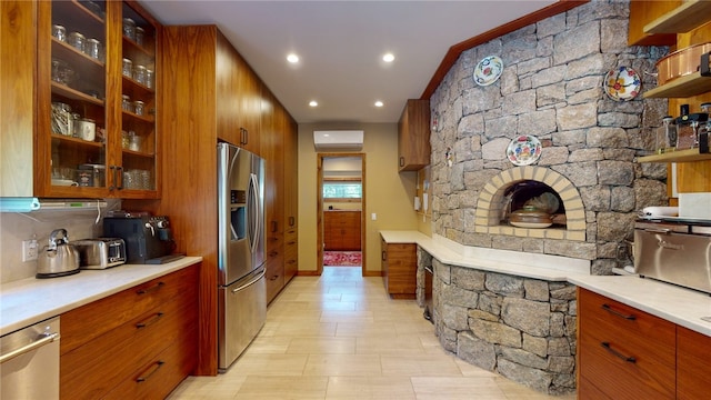 kitchen featuring a wall unit AC and appliances with stainless steel finishes