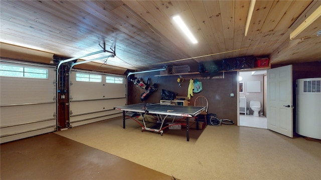 garage featuring wood ceiling and water heater