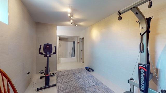 workout room featuring rail lighting