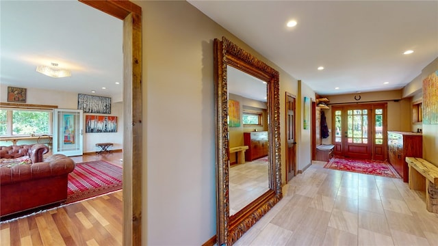 hallway with plenty of natural light and light hardwood / wood-style flooring