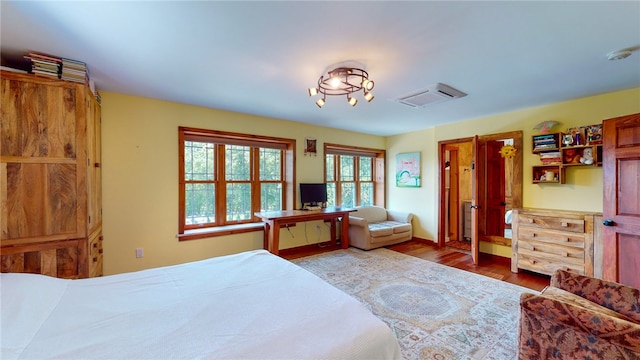 bedroom with hardwood / wood-style flooring