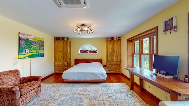 bedroom with dark hardwood / wood-style floors