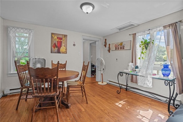 dining space with wood finished floors