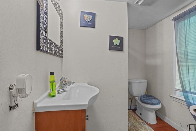 bathroom featuring hardwood / wood-style flooring, vanity, and toilet