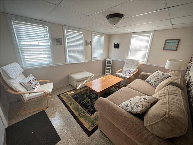 living room featuring plenty of natural light and a paneled ceiling