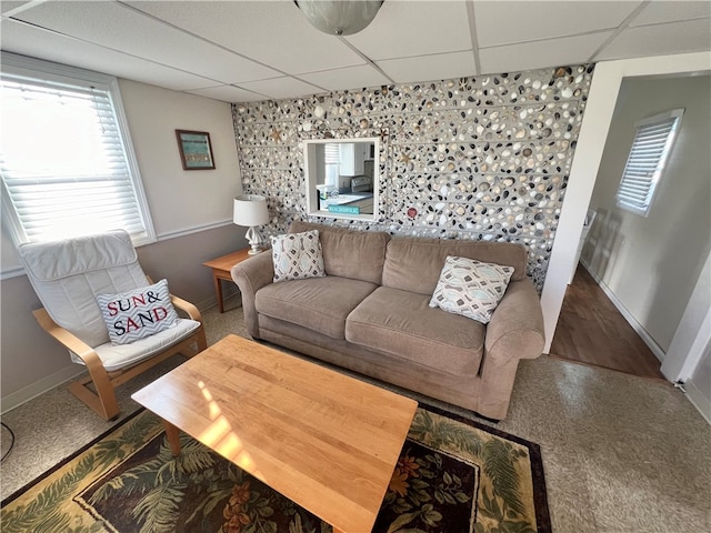 living room with hardwood / wood-style flooring and a paneled ceiling