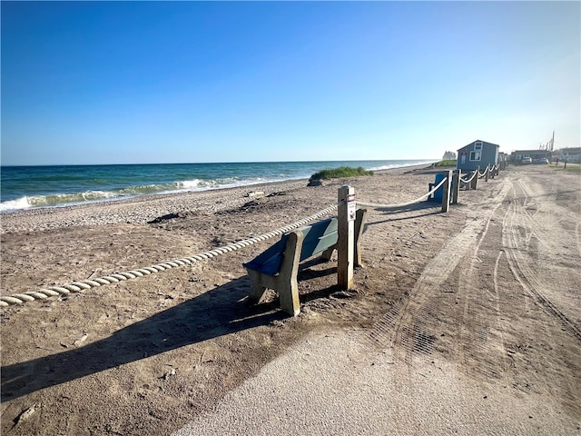 view of property's community featuring a beach view and a water view