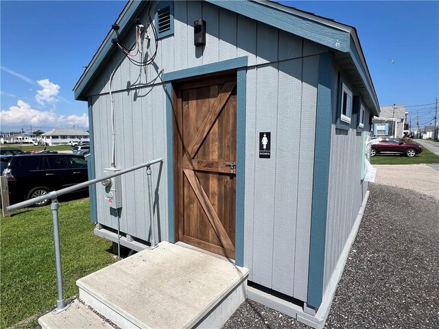 view of outbuilding featuring a yard