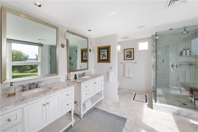 bathroom with a shower with door, vanity, and tile patterned floors