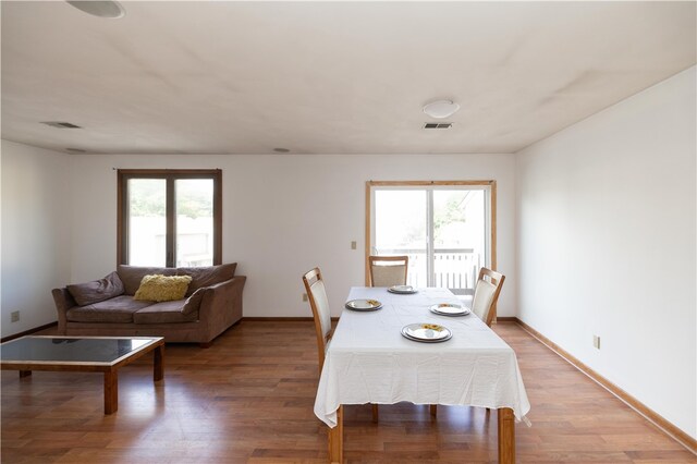 dining room featuring plenty of natural light and hardwood / wood-style flooring