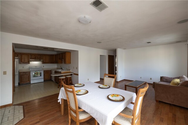 dining room with sink and tile patterned floors