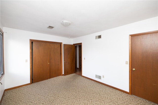 unfurnished bedroom with carpet and a closet