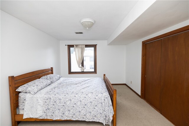 bedroom featuring a closet and light carpet