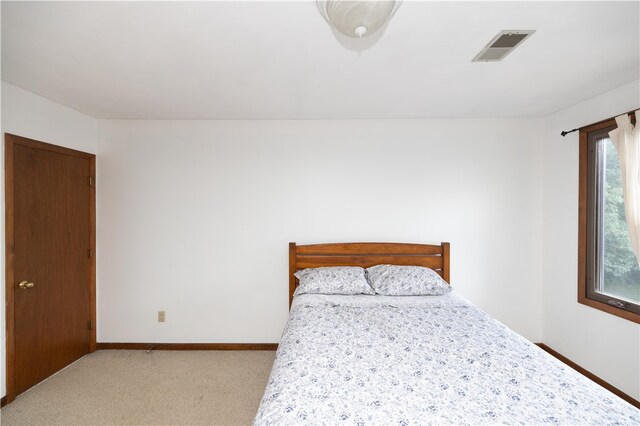 bedroom with light colored carpet