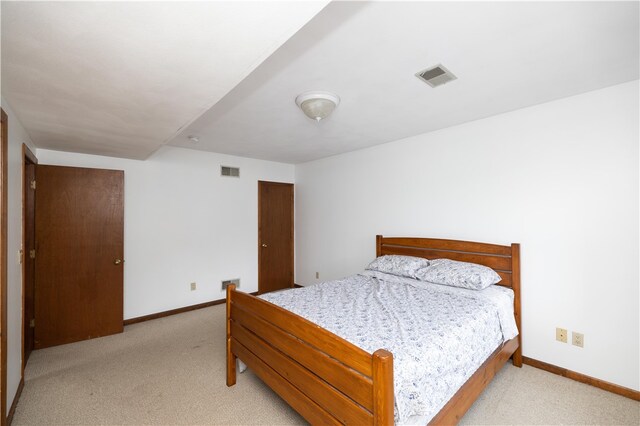 bedroom featuring light carpet