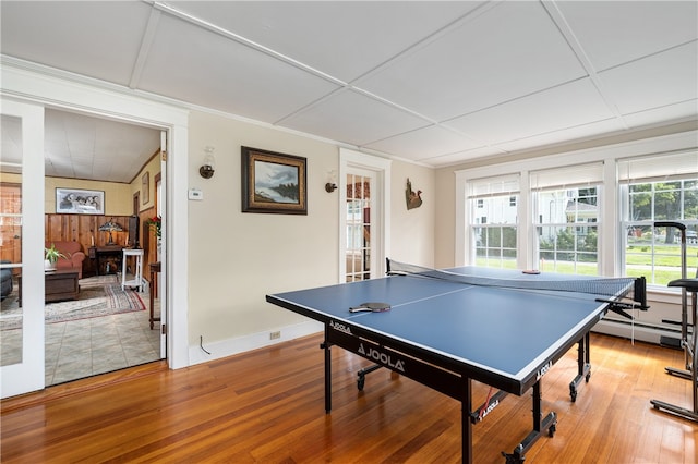 recreation room with hardwood / wood-style flooring and baseboard heating