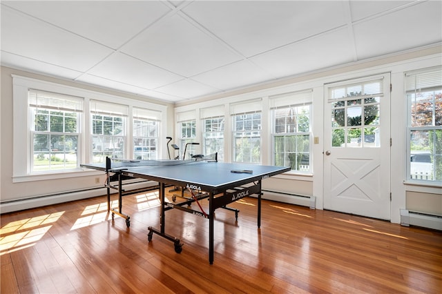 recreation room featuring a baseboard radiator and wood-type flooring