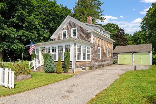 view of front of home with a storage shed and a front yard