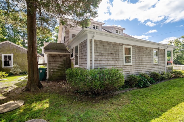 view of side of property with a yard