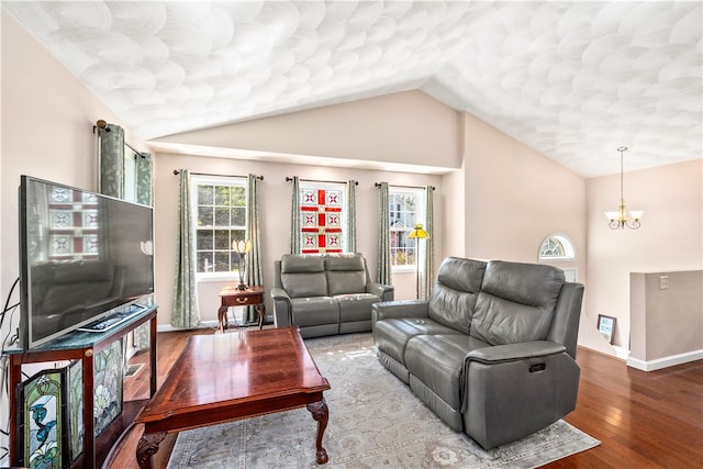 living room featuring an inviting chandelier, hardwood / wood-style flooring, and lofted ceiling