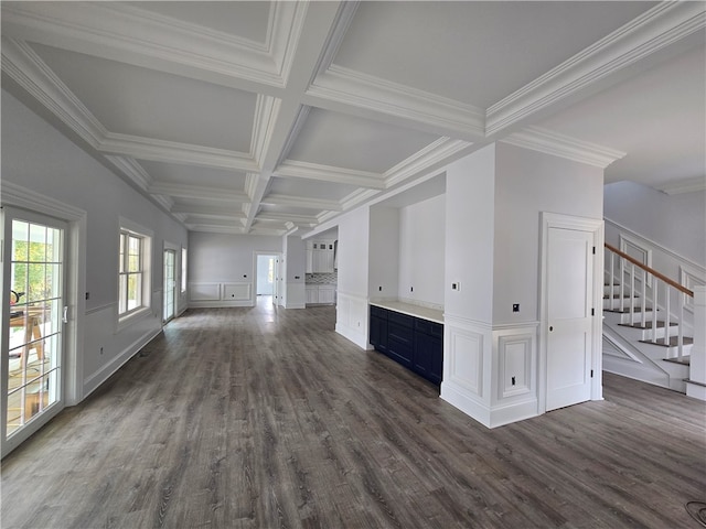 unfurnished living room featuring beam ceiling, coffered ceiling, ornamental molding, and dark hardwood / wood-style flooring