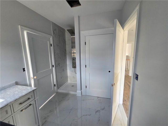 bathroom with vanity and tiled shower