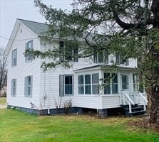 rear view of house with a yard