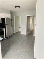 kitchen featuring white cabinets, tile patterned flooring, and stainless steel appliances