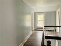 corridor featuring dark hardwood / wood-style flooring