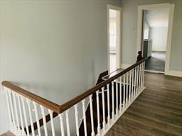 hallway with dark hardwood / wood-style flooring