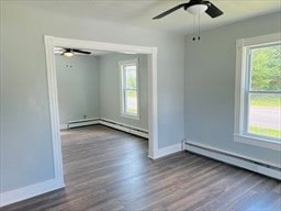 empty room with hardwood / wood-style floors, ceiling fan, and a healthy amount of sunlight