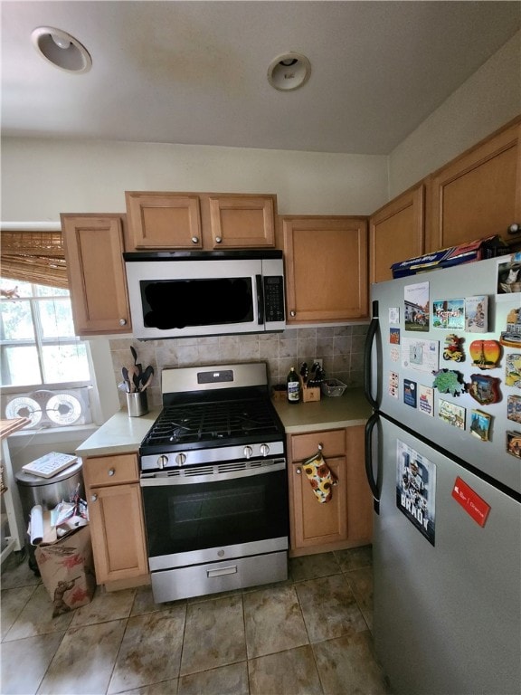 kitchen featuring appliances with stainless steel finishes and backsplash