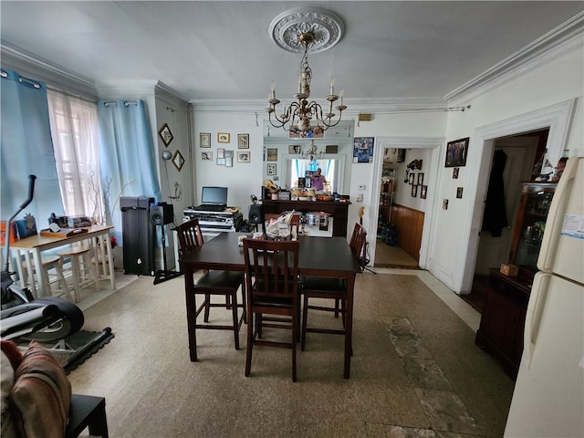 dining room featuring a chandelier and crown molding