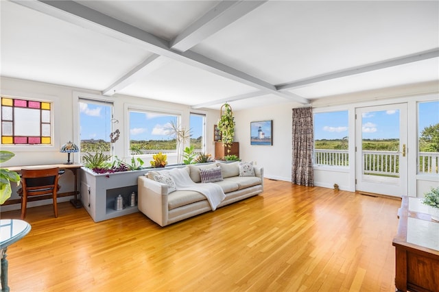 living room featuring light wood-type flooring and beam ceiling