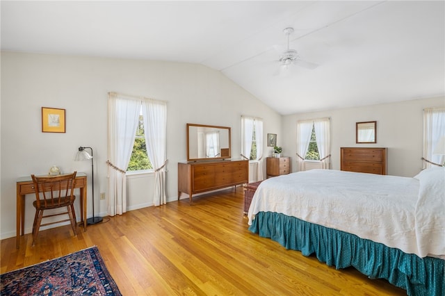 bedroom with vaulted ceiling, ceiling fan, and light hardwood / wood-style floors