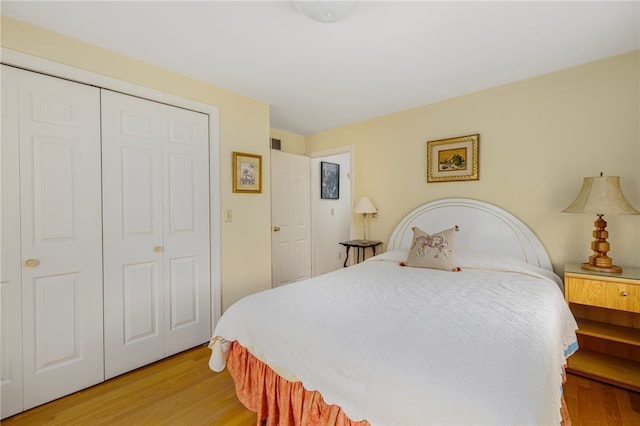 bedroom with a closet and light hardwood / wood-style floors