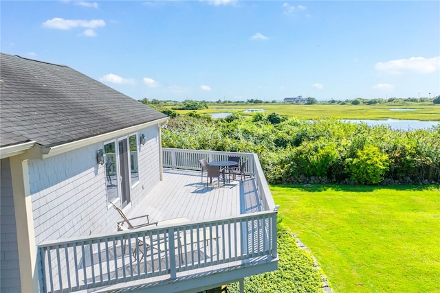 wooden deck featuring a yard and a water view