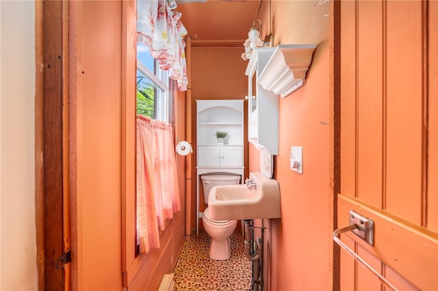 bathroom featuring tile patterned flooring, toilet, and sink