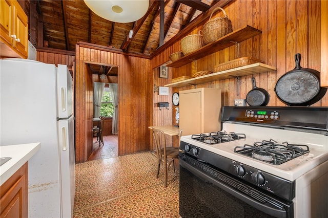 kitchen with white appliances, wood ceiling, wood-type flooring, wood walls, and vaulted ceiling with beams