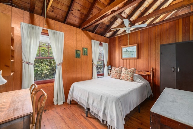 bedroom featuring wood ceiling, ceiling fan, wood walls, and vaulted ceiling with beams