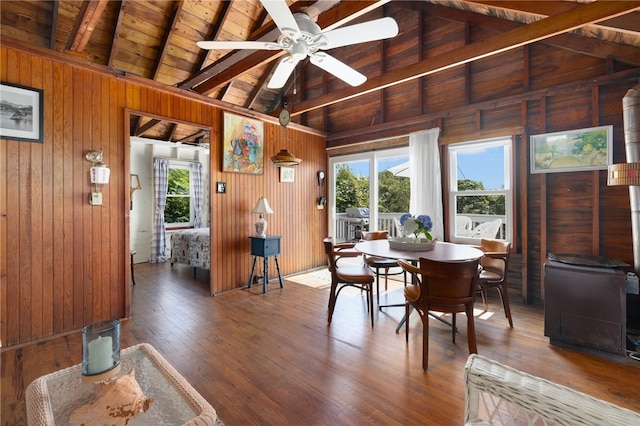 dining area with wood ceiling, plenty of natural light, wooden walls, and dark hardwood / wood-style flooring