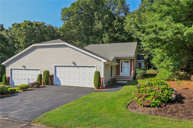 single story home featuring a garage and a front lawn