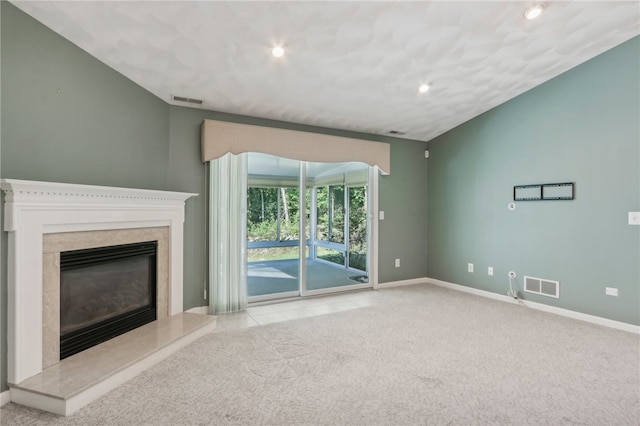 unfurnished living room with a premium fireplace and light colored carpet