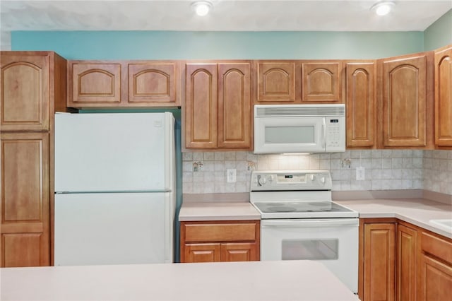 kitchen with white appliances and tasteful backsplash