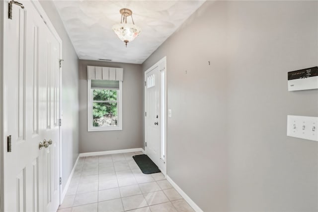 doorway with light tile patterned flooring