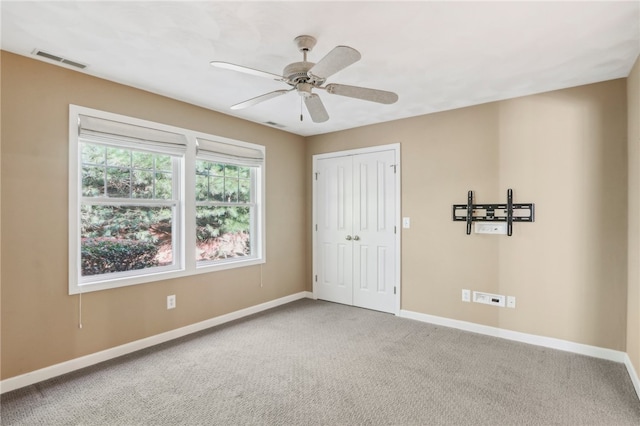 interior space with ceiling fan and carpet flooring