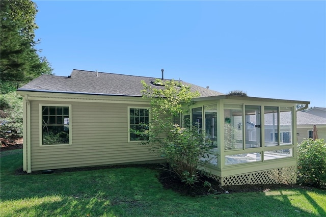 rear view of property featuring a lawn