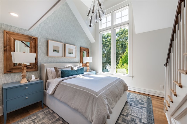 bedroom with dark wood-type flooring, an inviting chandelier, and high vaulted ceiling