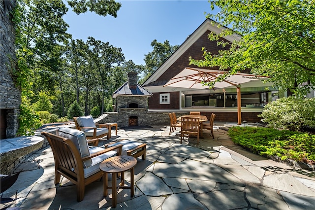 view of patio / terrace with an outdoor stone fireplace